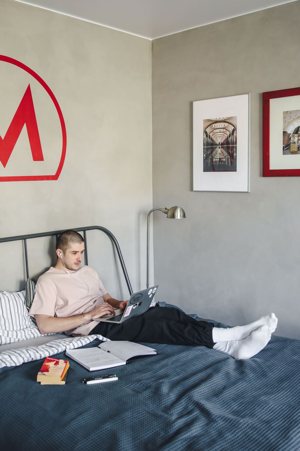 Guest working on a laptop in bed in a short-term rental
