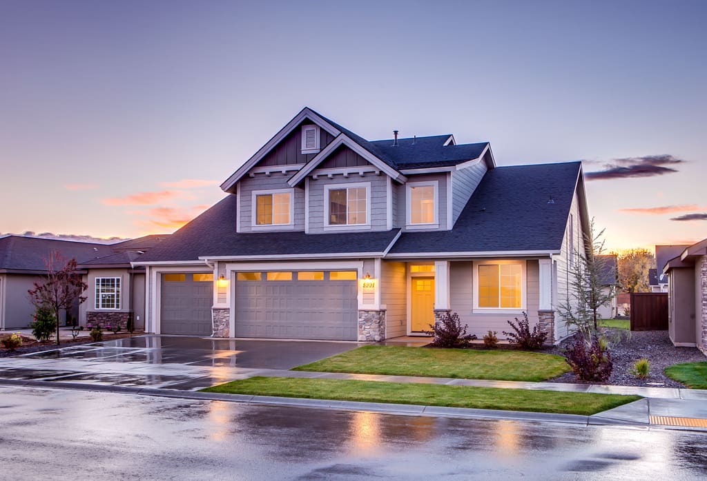 Twilight exterior photograph of a family home with the interior lights on