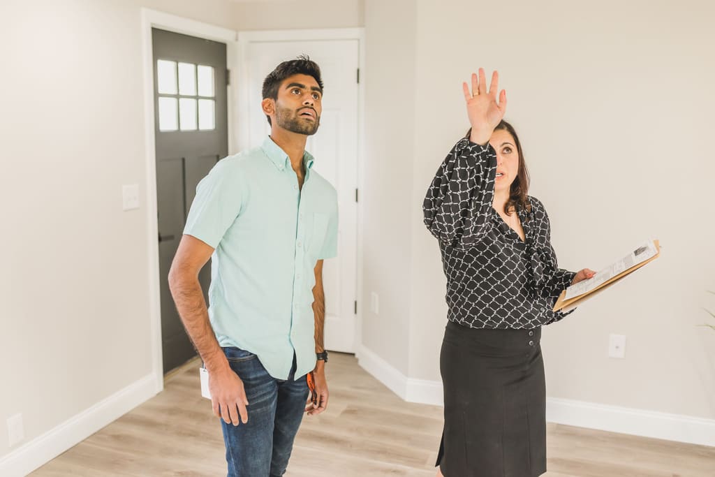 Manager with a clipboard checking a doorway during a property inspection