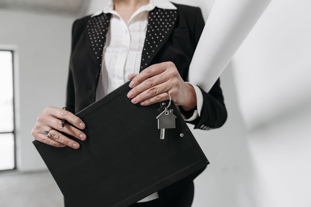 Property manager holding a folder and a set of house keys