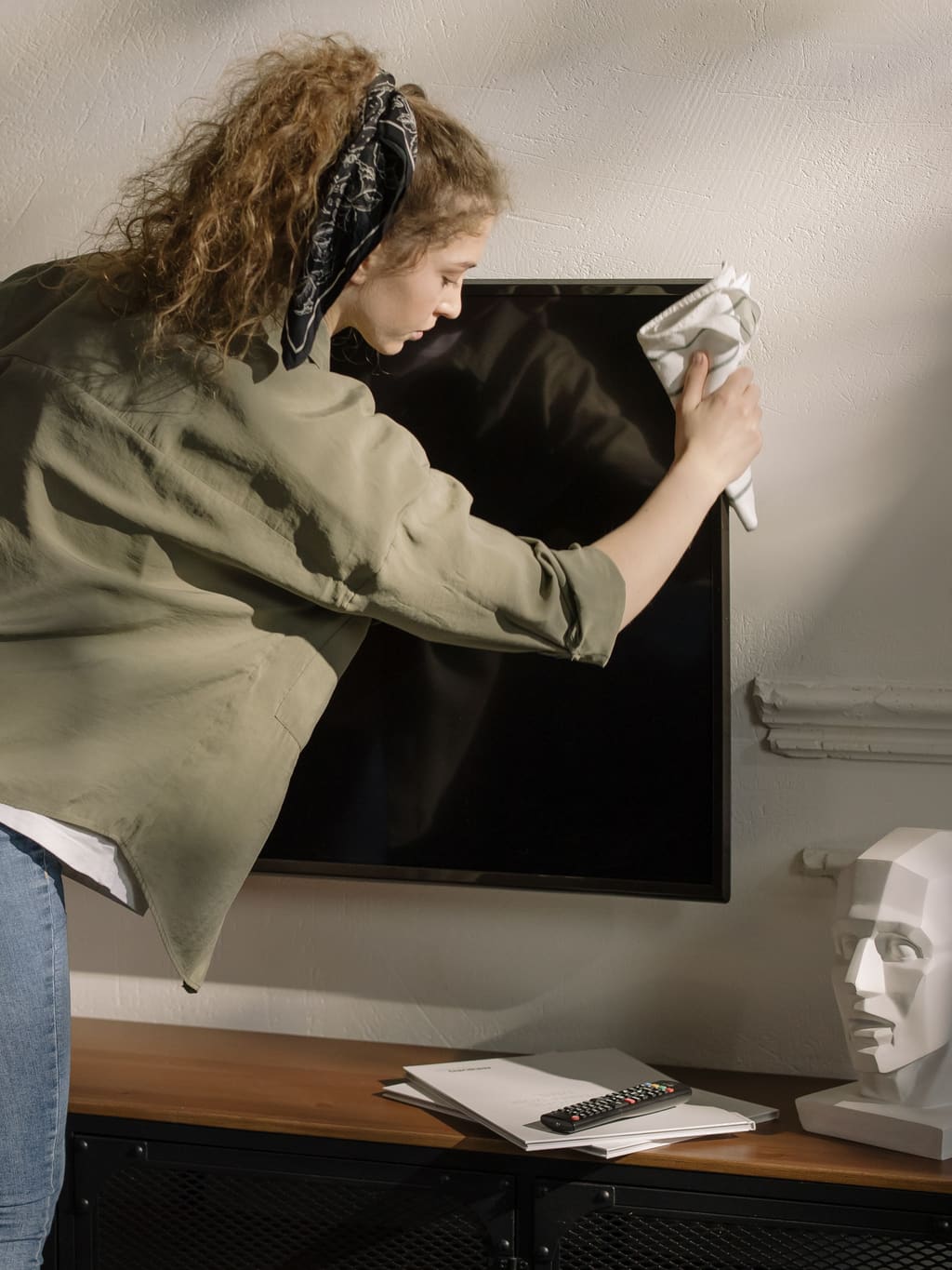 Tradesperson reaching up to work on a fitting near the ceiling