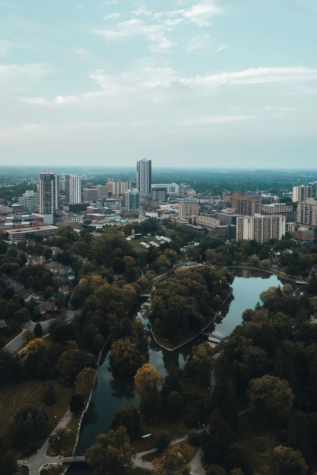 Aerial view over Waterloo Region at dusk, with the downtown towers and the river beyond