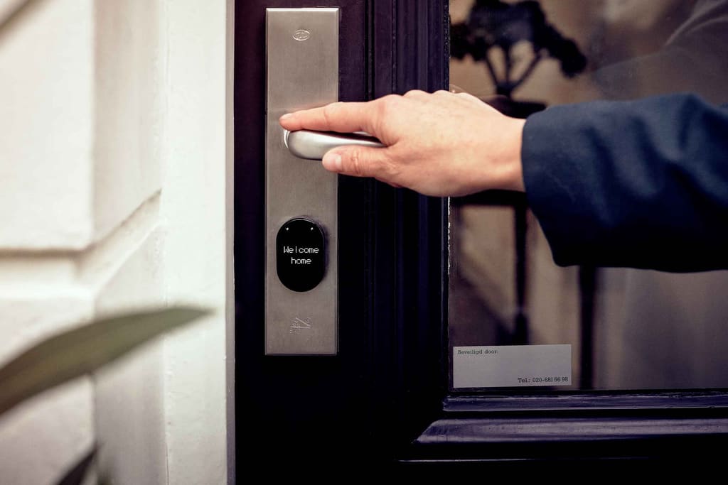 Hand unlocking a smart door lock with a digital access panel